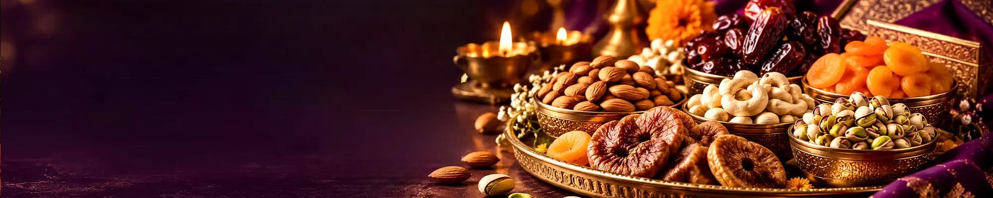 Almonds, cashews, pistachios, dates, figs and apricots in brass bowls with diyas